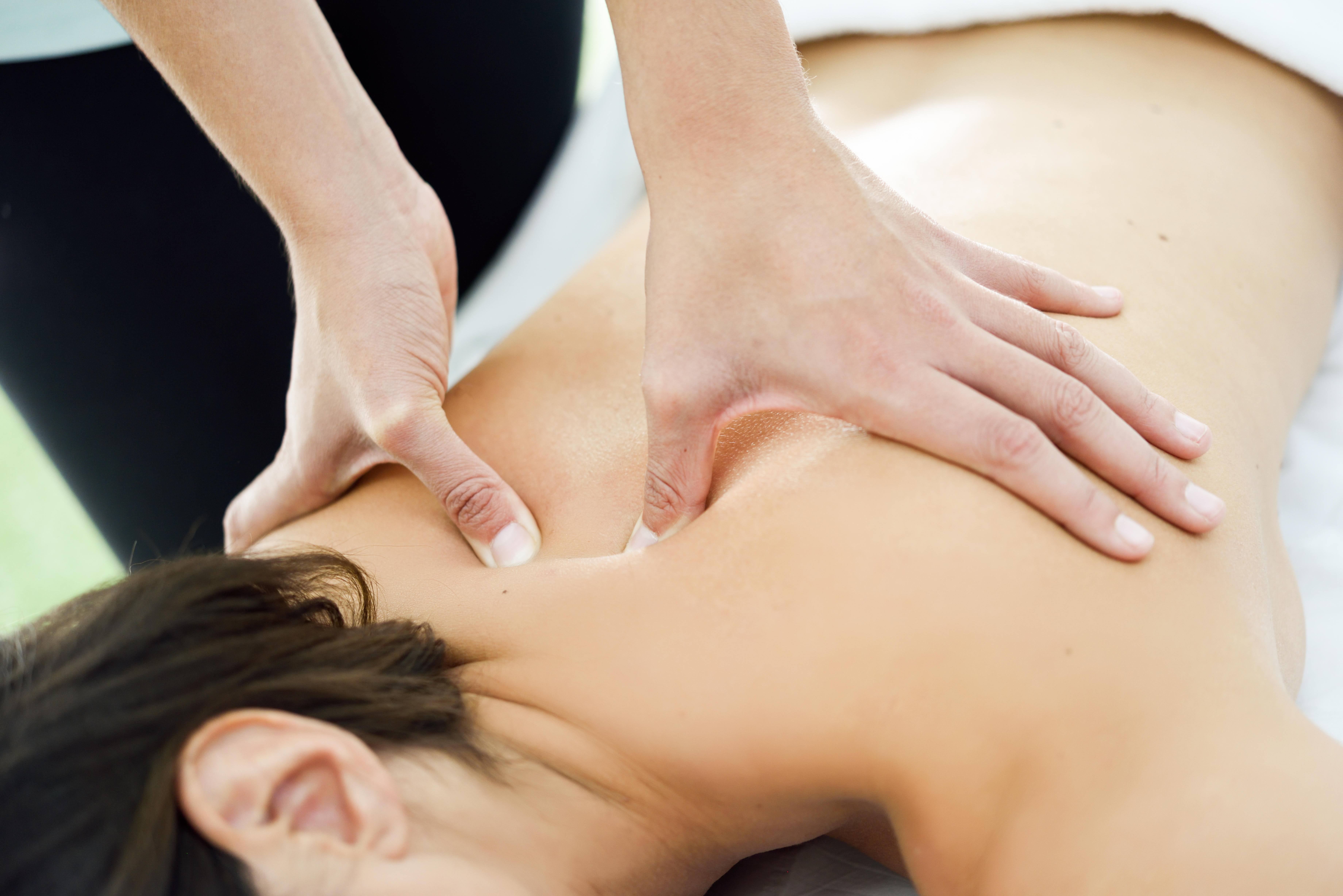 young-woman-receiving-back-massage-spa-center